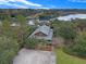 Stunning aerial view of a waterfront home nestled among lush greenery with access to a serene river at 4086 Lady Banks Ln, Ravenel, SC 29470