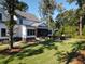 Manicured backyard featuring a screened porch and fenced in pool area at 4086 Lady Banks Ln, Ravenel, SC 29470