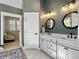 Beautiful bathroom featuring double sinks, black fixtures, and a doorway to a dressing area at 4086 Lady Banks Ln, Ravenel, SC 29470