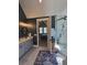 Well-lit bathroom with double vanity, glass shower, and doorway leading to bedroom at 4086 Lady Banks Ln, Ravenel, SC 29470