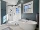 Modern bathroom featuring a soaking tub, tiled shower, and bright natural light at 4086 Lady Banks Ln, Ravenel, SC 29470