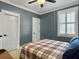 Bedroom featuring carpet floors, ceiling fan, blue accent wall and white trim at 4086 Lady Banks Ln, Ravenel, SC 29470