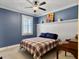 Bright bedroom featuring carpet floors, ceiling fan, blue accent wall and white trim at 4086 Lady Banks Ln, Ravenel, SC 29470