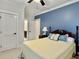 Bright bedroom featuring carpet floors, ceiling fan, blue accent wall and white trim at 4086 Lady Banks Ln, Ravenel, SC 29470
