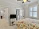 Bright bedroom featuring carpet floors, ceiling fan, ensuite bathroom and white trim at 4086 Lady Banks Ln, Ravenel, SC 29470