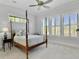 Bright bedroom featuring a four-poster bed, white walls and carpet, and shuttered windows at 4086 Lady Banks Ln, Ravenel, SC 29470