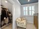 Dressing area with closet, window, and settee chair at 4086 Lady Banks Ln, Ravenel, SC 29470
