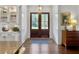 Welcoming foyer featuring a wood floor, double doors, and an elegant rug at 4086 Lady Banks Ln, Ravenel, SC 29470
