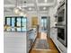 Bright kitchen featuring a large island, stainless steel appliances, and modern pendant lighting at 4086 Lady Banks Ln, Ravenel, SC 29470