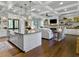 Open-concept kitchen with an island flows into the living room, featuring modern appliances and designer finishes at 4086 Lady Banks Ln, Ravenel, SC 29470