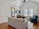 Bright living room with vaulted ceilings, a modern ceiling fan, and large windows at 4086 Lady Banks Ln, Ravenel, SC 29470