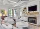 Comfortable living room with a brick fireplace, white furniture, and a coffered ceiling at 4086 Lady Banks Ln, Ravenel, SC 29470