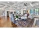 Open-concept living room with coffered ceilings, hardwood floors, and modern furnishings at 4086 Lady Banks Ln, Ravenel, SC 29470