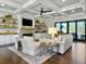 Cozy living room featuring a fireplace, built-in shelving, and sliding glass doors at 4086 Lady Banks Ln, Ravenel, SC 29470
