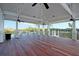 Spacious outdoor deck with ceiling fans, wood floors, and waterfront views, ideal for entertaining or relaxing at 4086 Lady Banks Ln, Ravenel, SC 29470