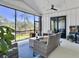 Relaxing screened porch featuring wicker furniture, ceiling fan, and serene outdoor views at 4086 Lady Banks Ln, Ravenel, SC 29470