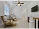 Bright sitting room with chairs, poufs, and a ceiling fan at 4086 Lady Banks Ln, Ravenel, SC 29470
