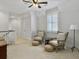 Cozy sitting room with striped chairs, poufs, and a ceiling fan at 4086 Lady Banks Ln, Ravenel, SC 29470