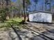 Large backyard with a grassy area, gravel groundcover, and a newly planted row of shrubbery at 4532 S Carolina # 41, Huger, SC 29450