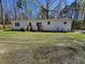 Large backyard with two entrances, a lush lawn, and a gravel parking pad at 4532 S Carolina # 41, Huger, SC 29450