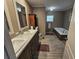 Bathroom featuring double sinks, soaking tub, and wood-look floors at 4532 S Carolina # 41, Huger, SC 29450