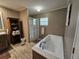 Bathroom showcasing a soaking tub, a sink vanity, and a glass-door shower at 4532 S Carolina # 41, Huger, SC 29450