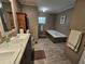 Bathroom featuring double sinks, soaking tub, and wood-look floors at 4532 S Carolina # 41, Huger, SC 29450