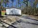 Exterior side view of home featuring gravel driveway and manicured landscaping at 4532 S Carolina # 41, Huger, SC 29450