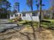 Well-maintained single story home featuring vinyl siding, blue shutters, and a newly constructed front porch at 4532 S Carolina # 41, Huger, SC 29450
