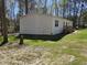 Exterior side view of home featuring a lush lawn and manicured landscaping at 4532 S Carolina # 41, Huger, SC 29450