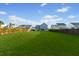 Huge backyard featuring a well-kept lawn and a view of houses beyond the wooden fence at 460 Cool Bend Ln, Summerville, SC 29486