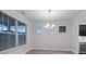 Bright dining room with a modern chandelier, three windows, and a view into the wet bar at 460 Cool Bend Ln, Summerville, SC 29486
