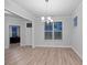 Open dining room with wood floors, large windows, and a view of an office at 460 Cool Bend Ln, Summerville, SC 29486