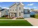 Charming two-story home with gray siding, a well manicured lawn, and a two-car garage at 460 Cool Bend Ln, Summerville, SC 29486