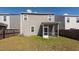 Back exterior of a two-story home with a screened porch and a grassy yard at 4809 Bushel Rd, Ladson, SC 29456