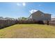 Large, grassy backyard enclosed by a wooden fence, perfect for outdoor activities at 4809 Bushel Rd, Ladson, SC 29456