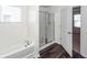 Bright bathroom with a tub and glass-enclosed shower, offering a modern design at 4809 Bushel Rd, Ladson, SC 29456
