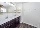 Bathroom featuring a double vanity with dark cabinets and wood-look floors at 4809 Bushel Rd, Ladson, SC 29456