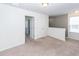 Bright bedroom features white walls and carpet, natural lighting, and doorway access at 4809 Bushel Rd, Ladson, SC 29456