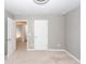 Neutral bedroom features light-gray walls, cream carpet, white doors, and natural lighting at 4809 Bushel Rd, Ladson, SC 29456