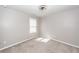 This empty bedroom has carpeted floors, a window with white blinds, and a modern ceiling fan at 4809 Bushel Rd, Ladson, SC 29456