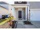 Charming entryway featuring a dark door, white pillars, and a landscaped flower bed at 4809 Bushel Rd, Ladson, SC 29456