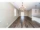 Open-concept living area with hardwood floors, chandelier, and access to the kitchen at 4809 Bushel Rd, Ladson, SC 29456