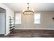 Bright living room with hardwood floors, chandelier, and two large windows at 4809 Bushel Rd, Ladson, SC 29456
