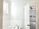Bathroom featuring a white tub and white tiled walls, with a window at 482 Oak View Way, Summerville, SC 29483
