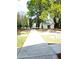 Exterior shot of a community building with sidewalk and adjacent grassy area and mature landscaping and a walking path at 482 Oak View Way, Summerville, SC 29483