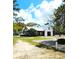 Exterior shot of a charming community building with covered area, lush landscaping and outdoor seating at 482 Oak View Way, Summerville, SC 29483