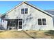 The back of a house features a screened porch, and a well-maintained lawn under a clear blue sky at 482 Oak View Way, Summerville, SC 29483