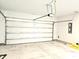 An empty two car garage with a concrete floor and a modern garage door opener ready for vehicles or storage at 482 Oak View Way, Summerville, SC 29483