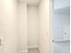 A hallway leads to a carpeted room with neutral walls and modern fixtures throughout the well-lit space at 482 Oak View Way, Summerville, SC 29483